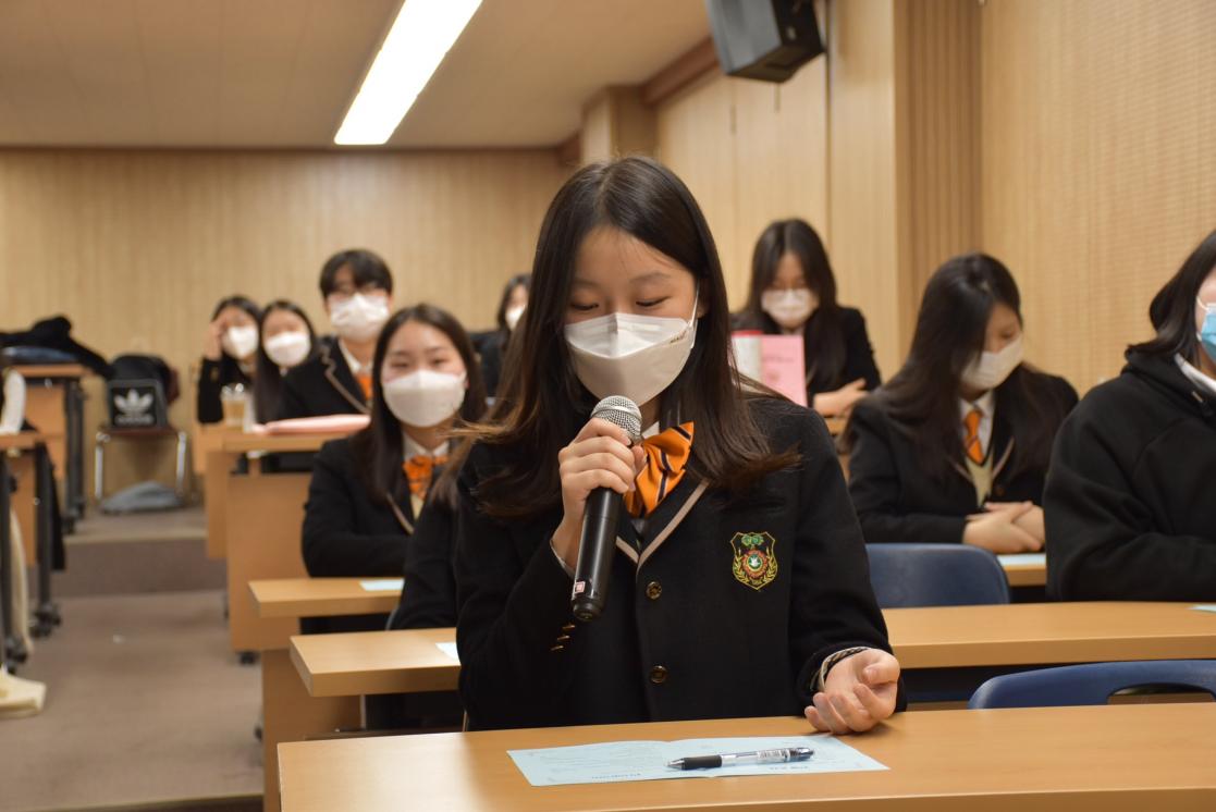 Student speaking into a microphone