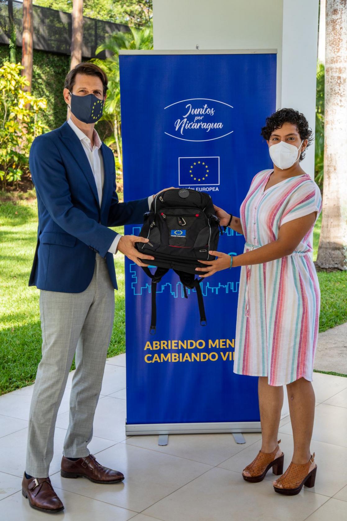 Man and woman holding a backpack