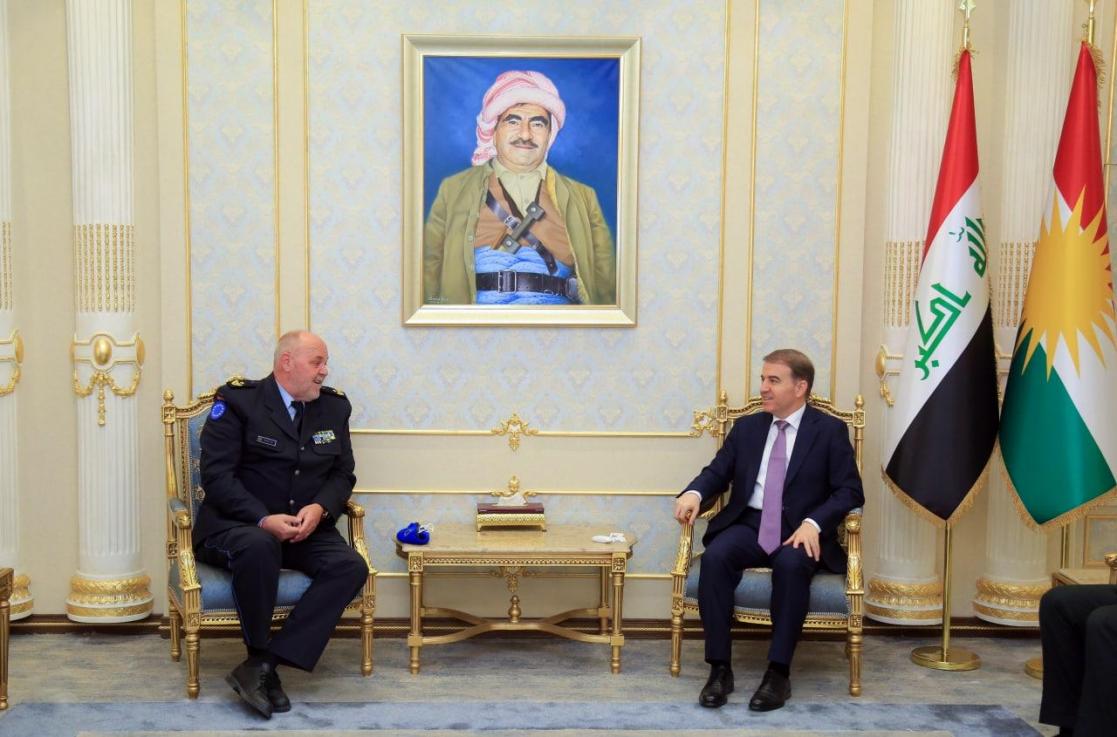 Two men sitting on chairs talking
