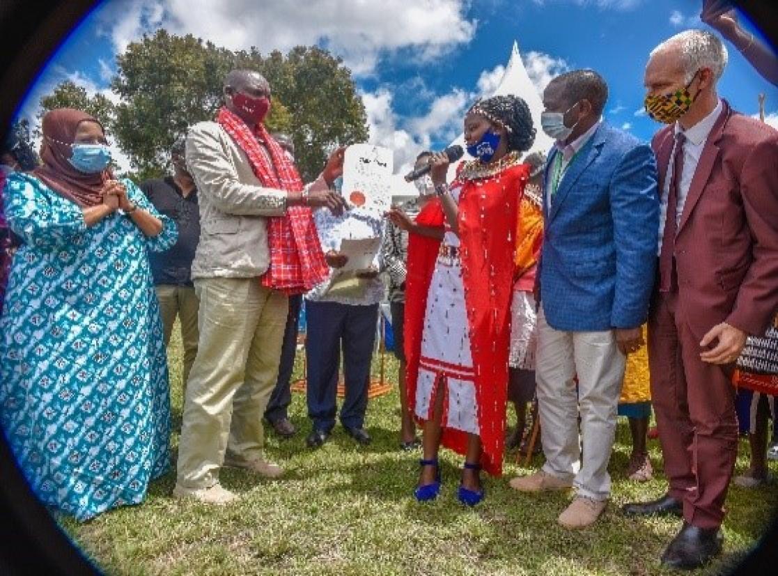 Group of people holding a document together