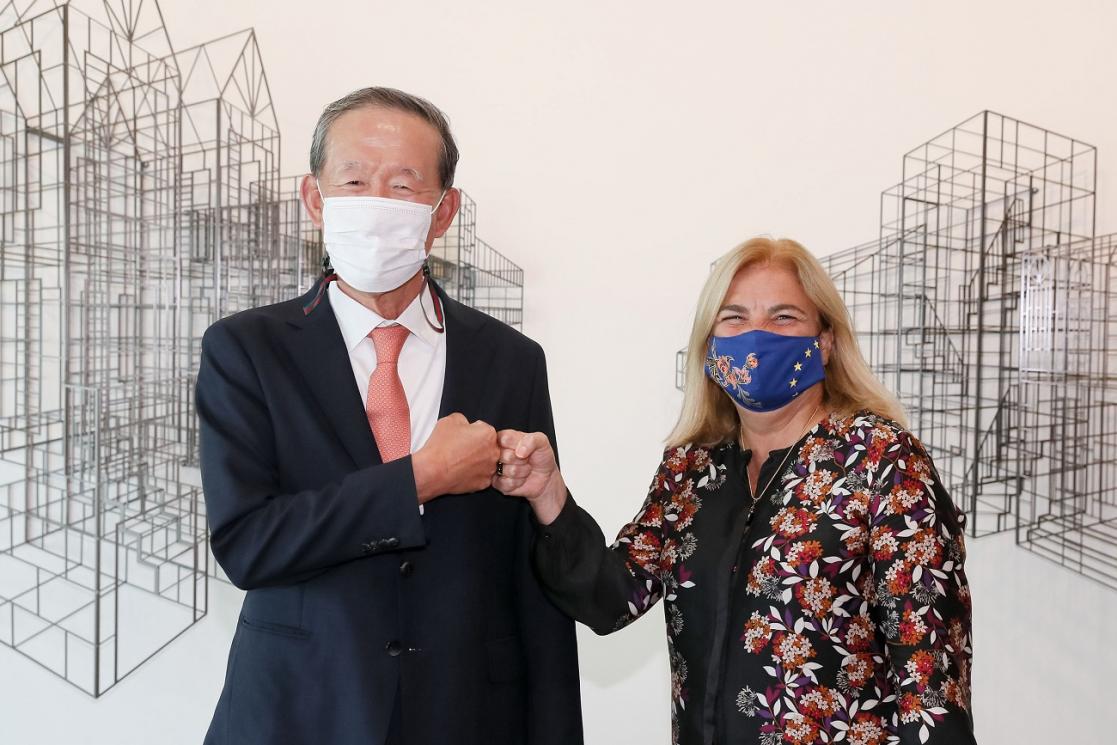 Two people with masks clash fists