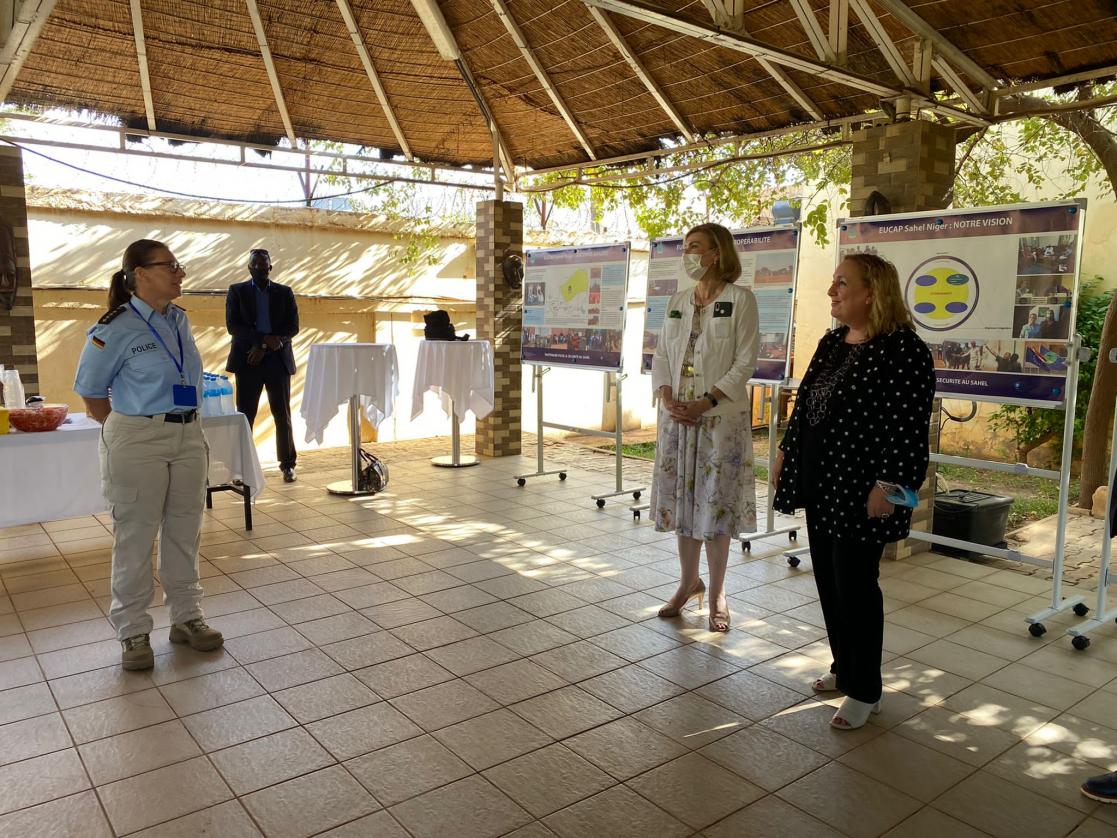 Four people standing during an exhibition
