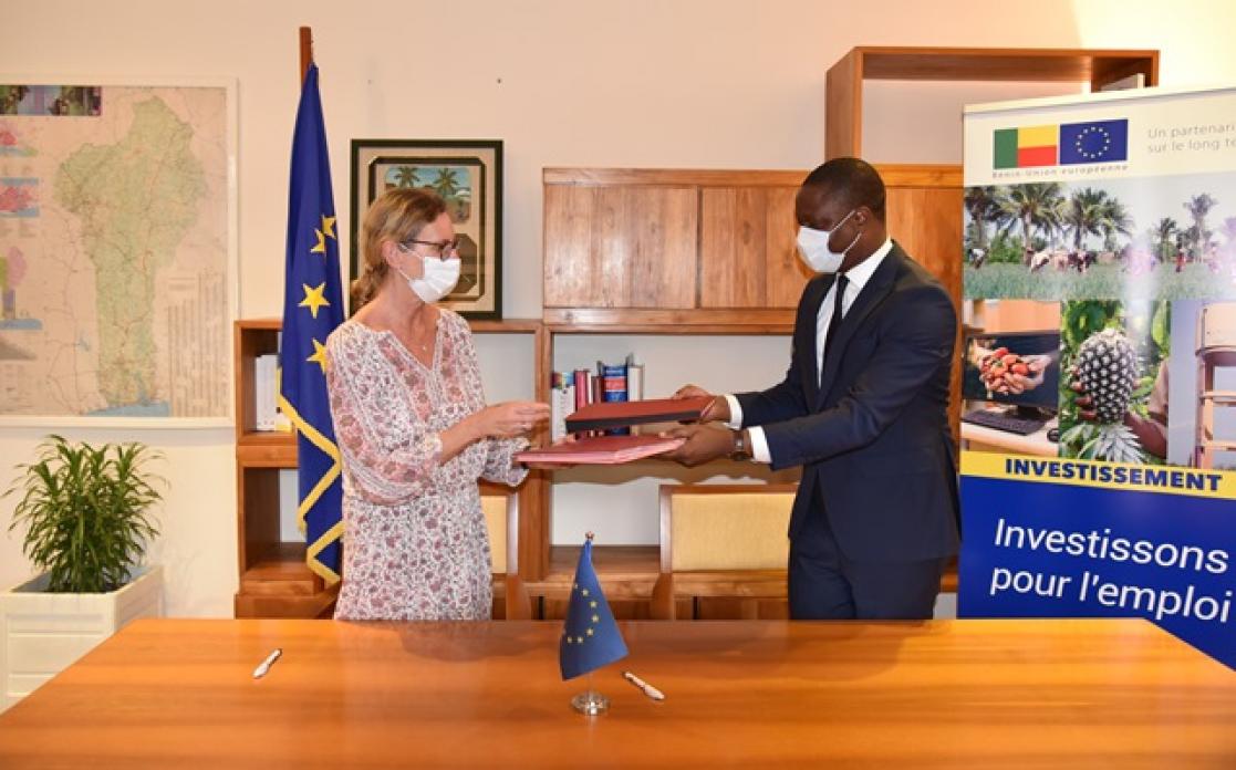 Two people exchanging documents