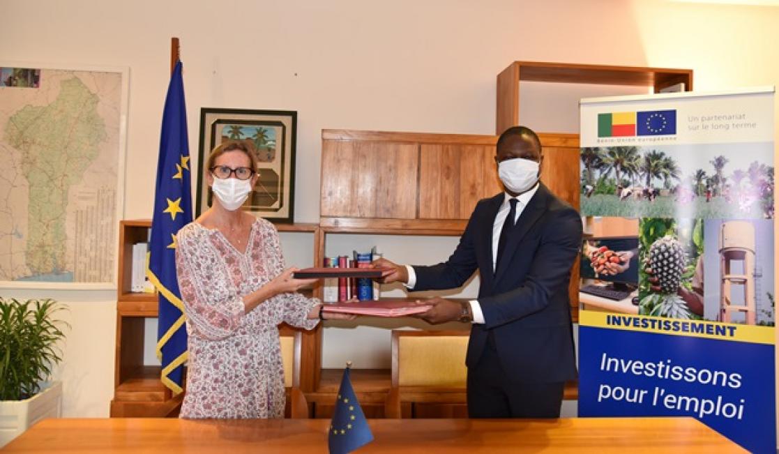 Two people exchanging documents
