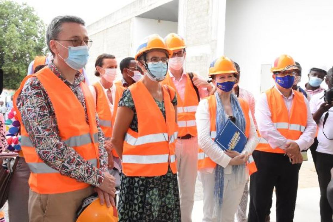 Group of people wearing helmets and safety waistcoats