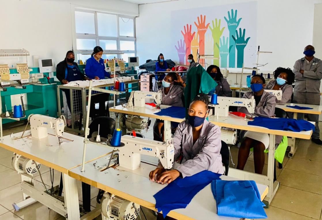 Women sewing with sewing machines in a workshop