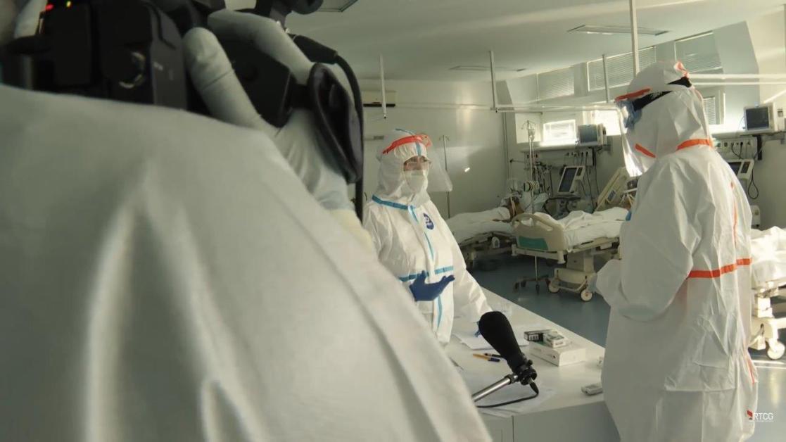 Medical personnel wearing safety overalls