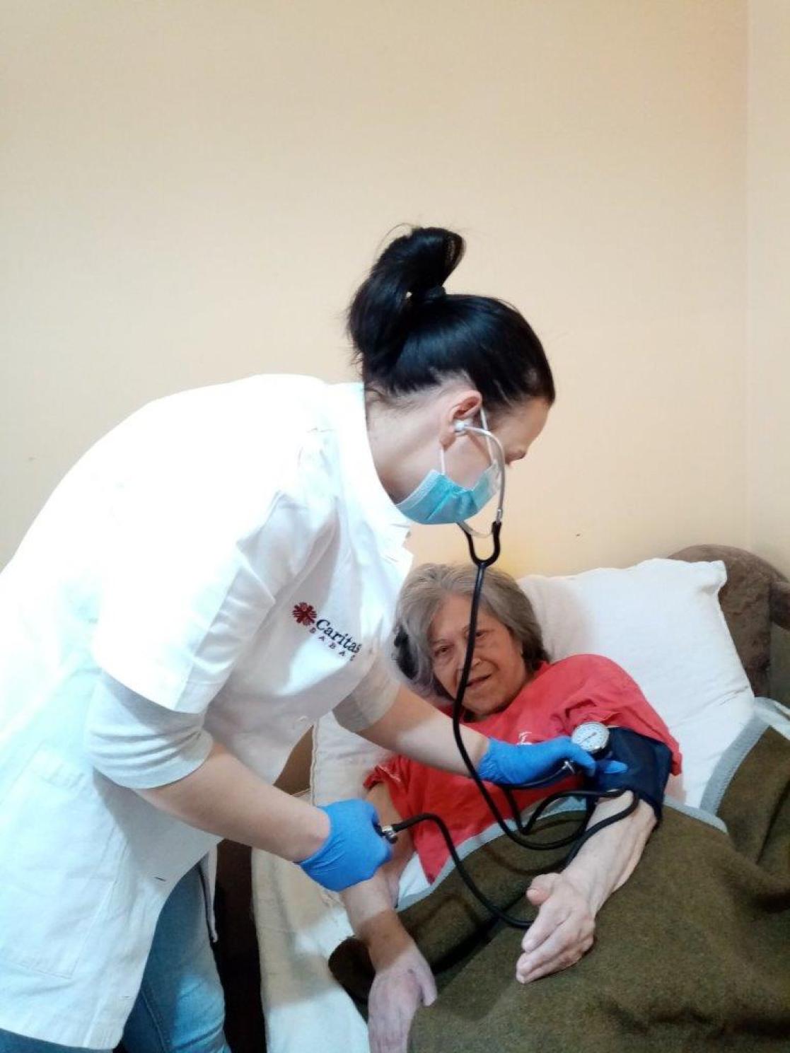 Nurse attending to an elderly woman