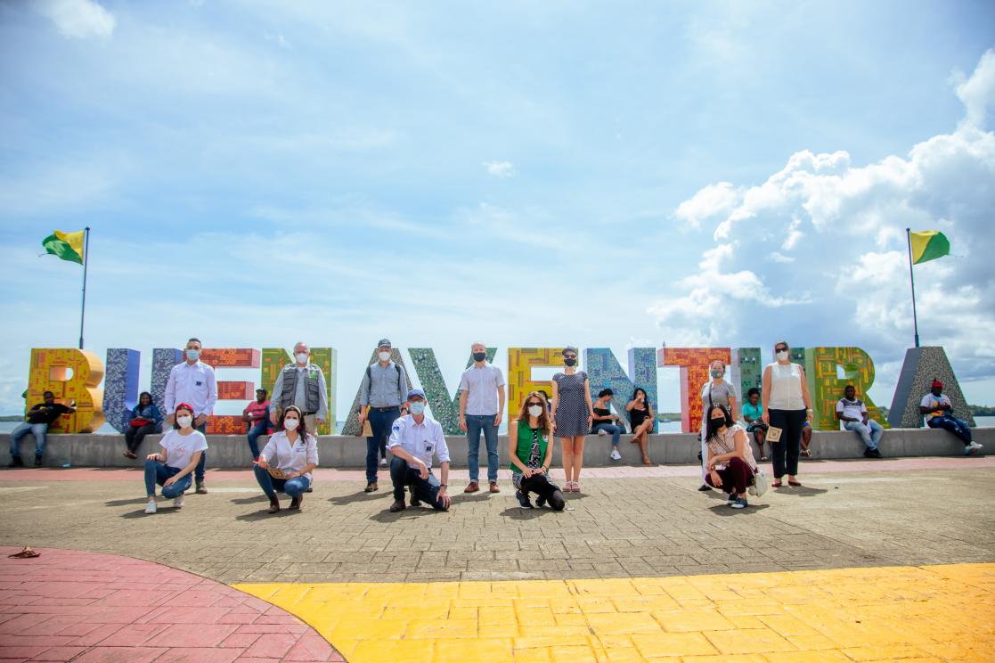 Group of people posing in front of Buenaventura banner