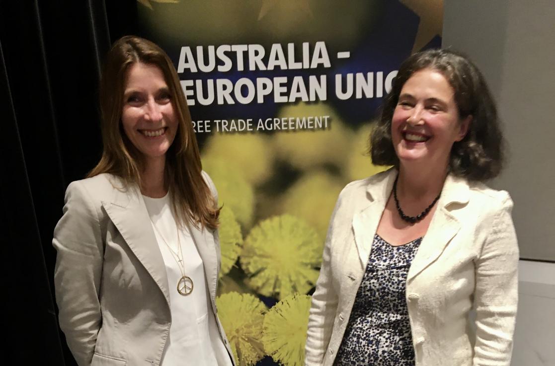 person posing in front of a banner