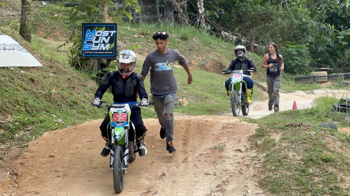 Two people riding motorbikes in the countryside