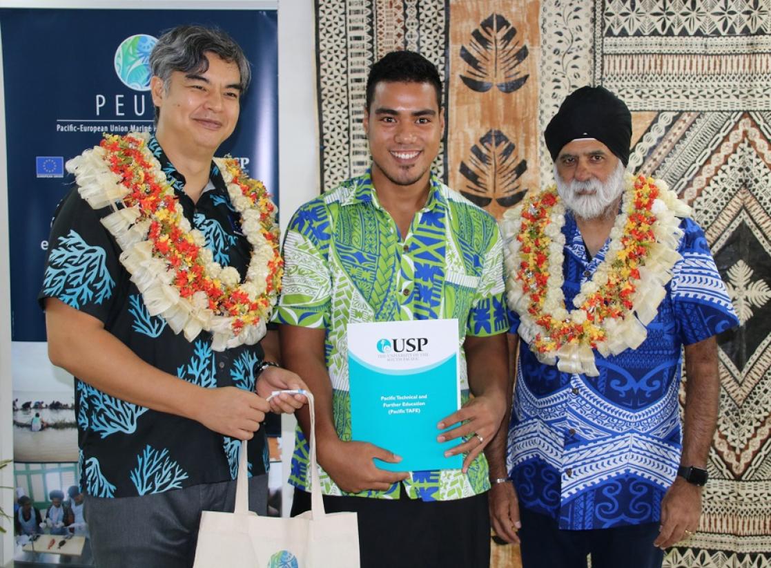 People posing with documents and a bag
