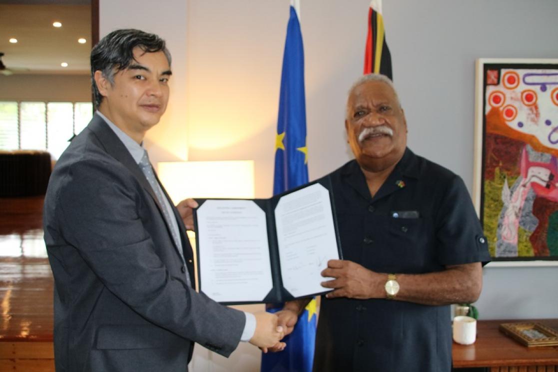 Two men holding a document