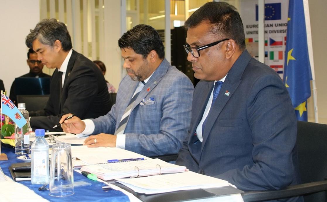 Three men during a conference