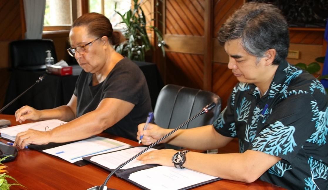 Man and woman signing documents