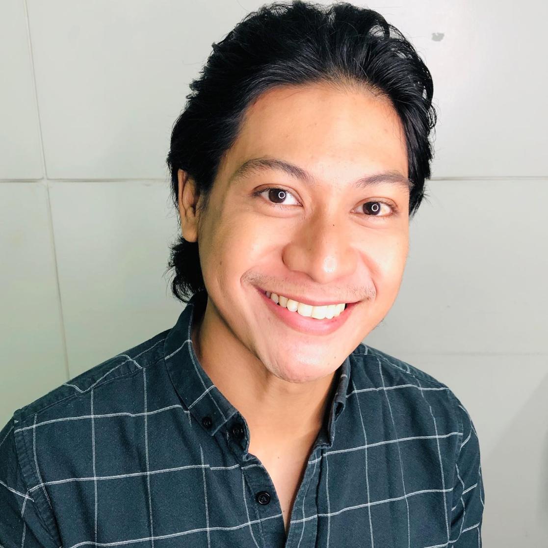 Man smiling in front of the camera