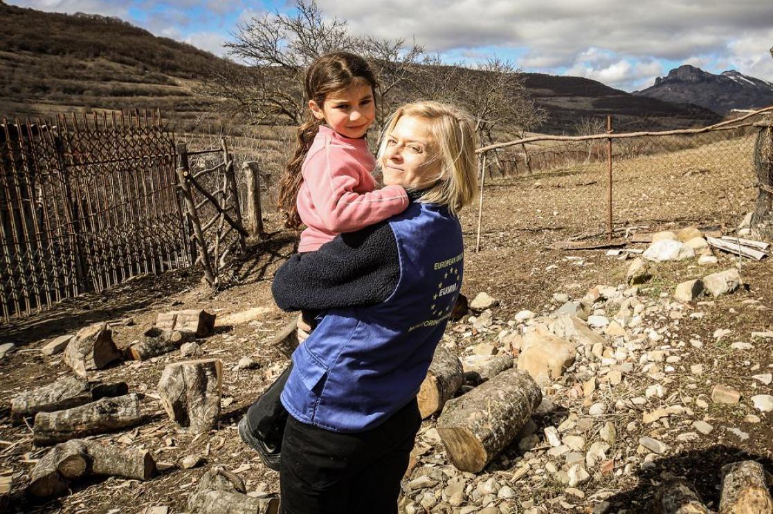 Woman holding a child in her arms