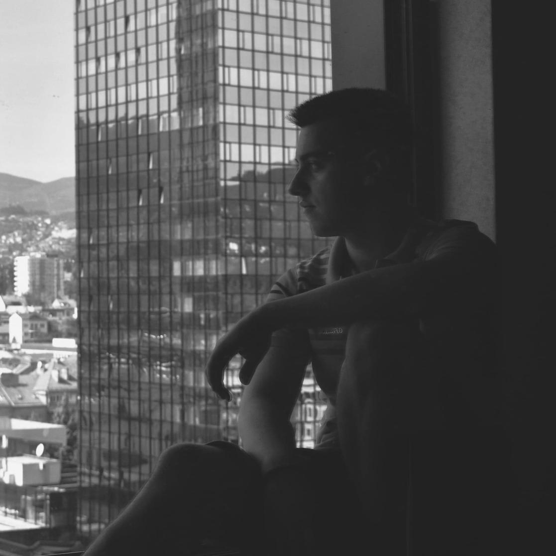 Young man looking out of the window