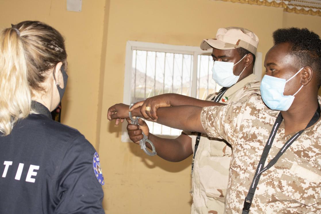 Protagonists practise handcuffing