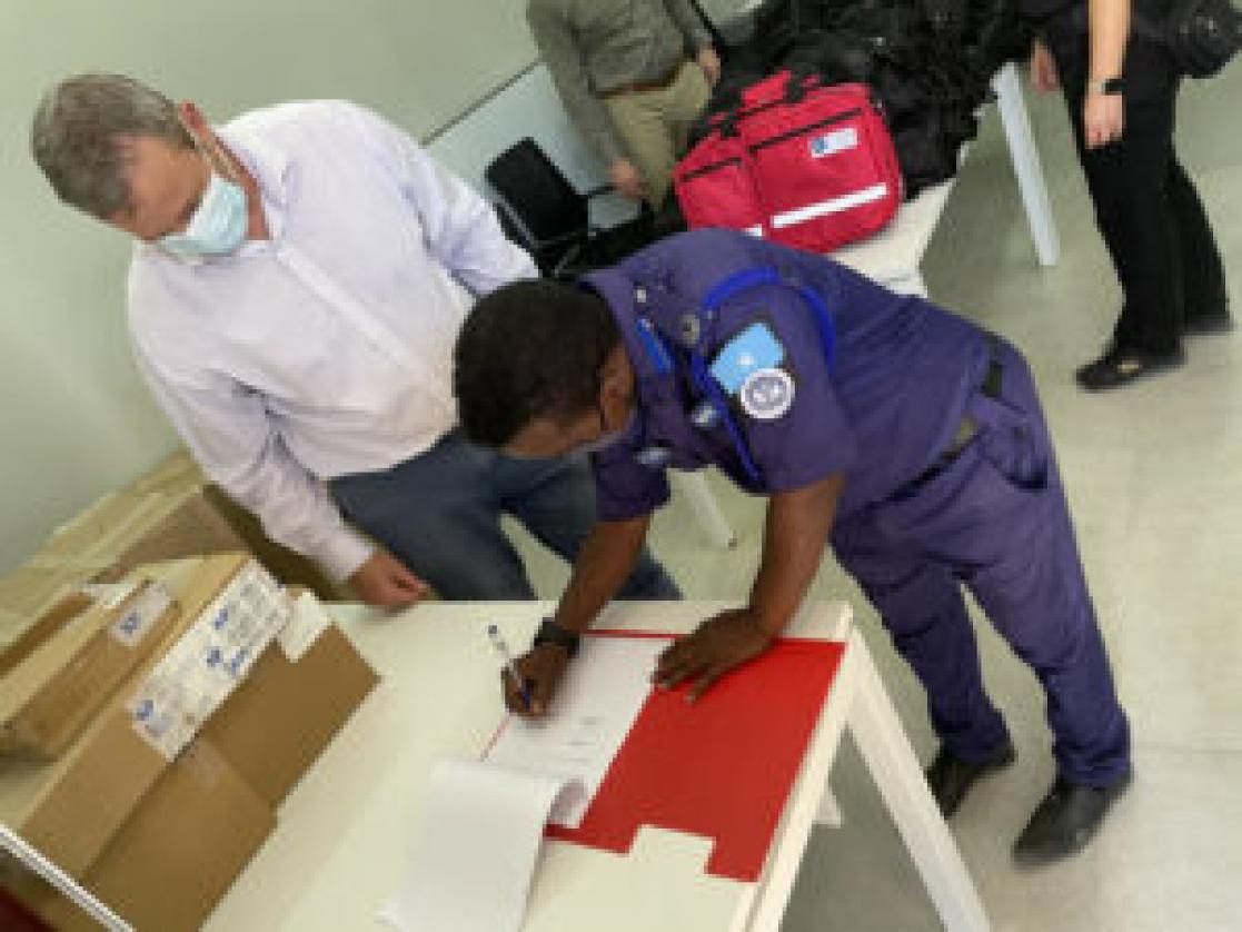 a man signing a document 