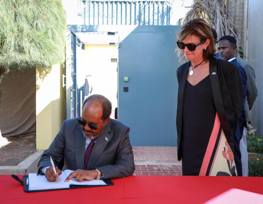 President Hassan Sheikh Mohamud signs the guest book at the EU Compound in Mogadishu.
