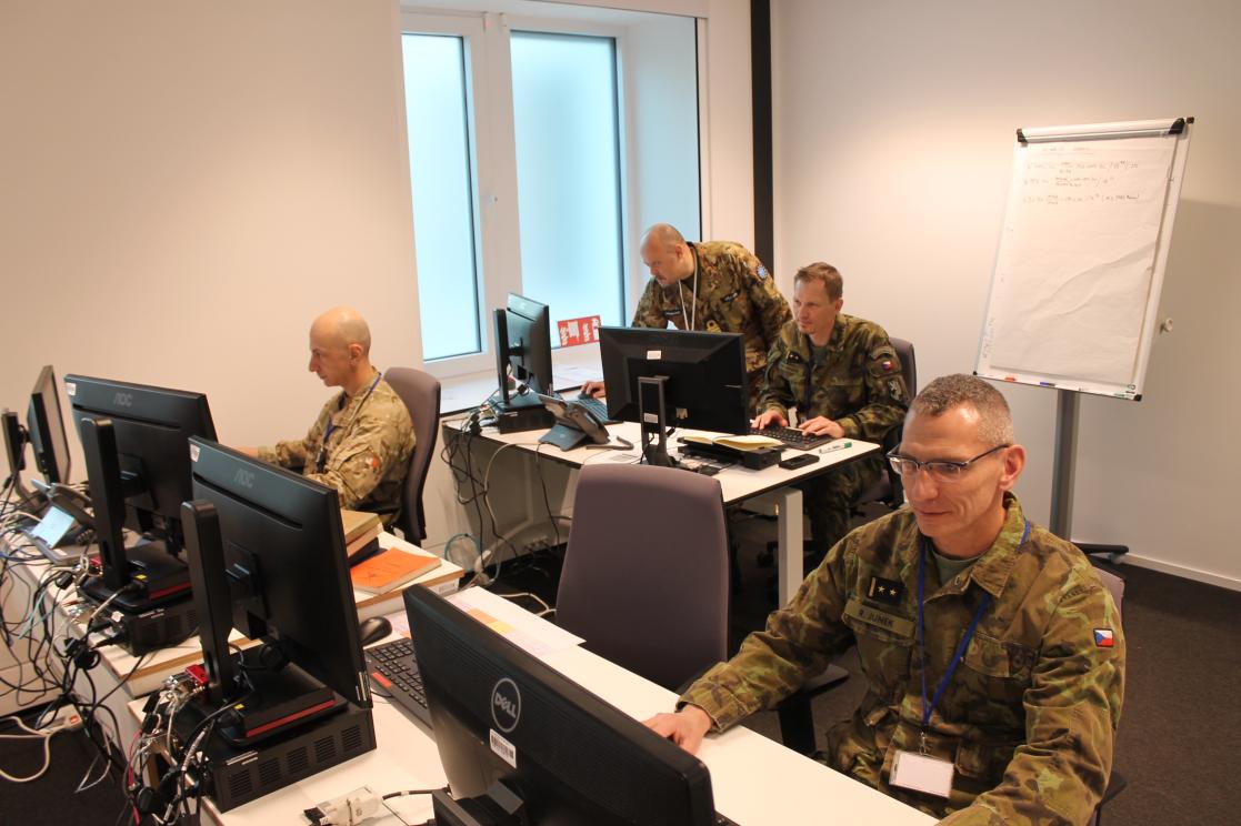 Military personnel at a live desktop exercise.