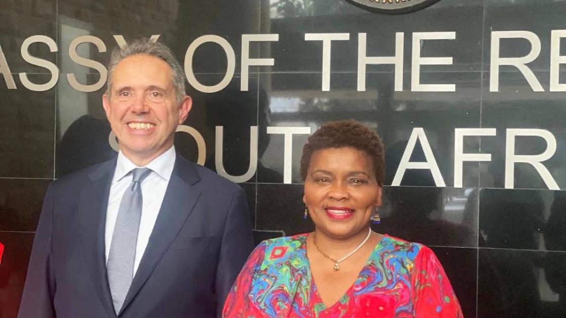 A man and a woman senior officials pose.