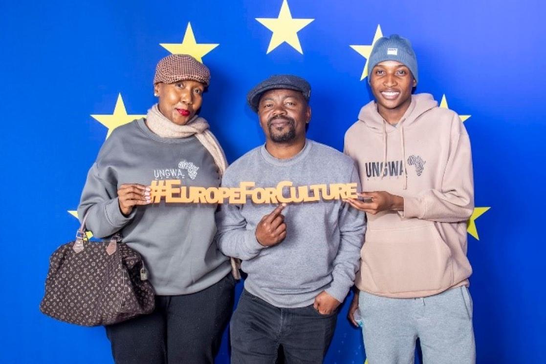 Three film goers stand in front of an EU background