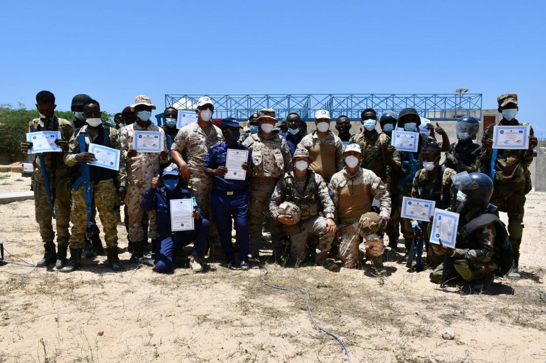 group photo with diplomas in hand 
