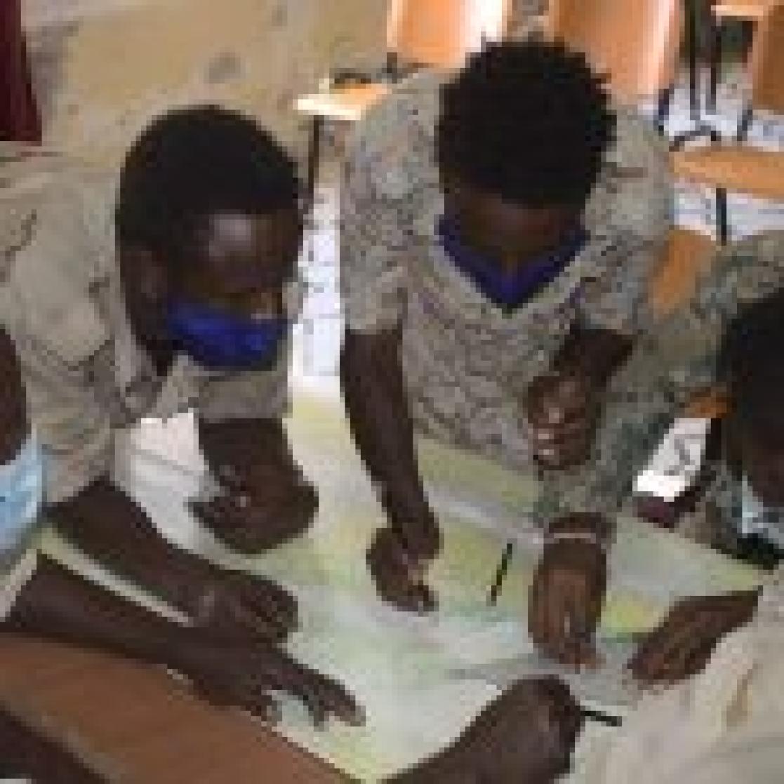 group of people looking into a map
