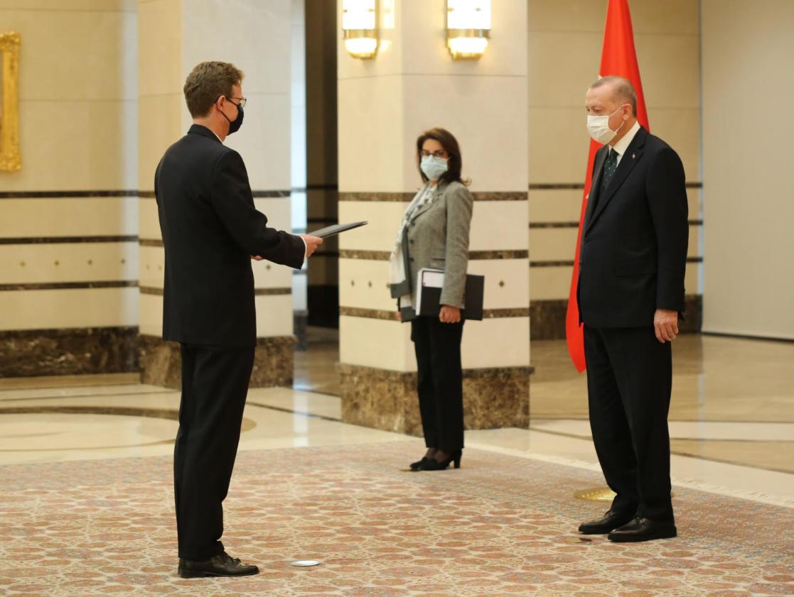 Two men about to shake hands