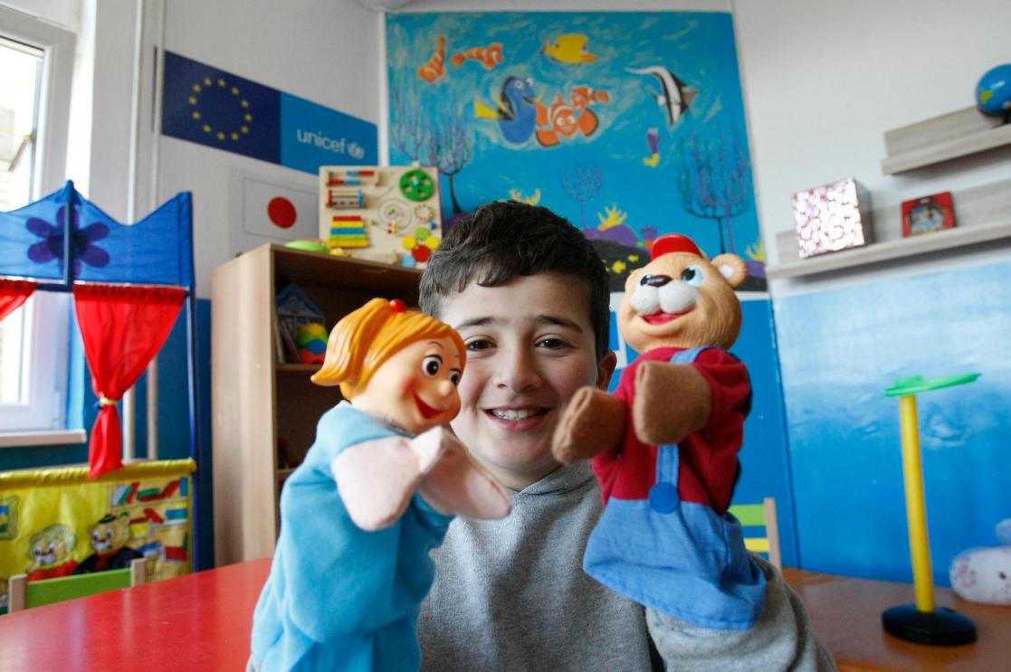 Child playing with puppets