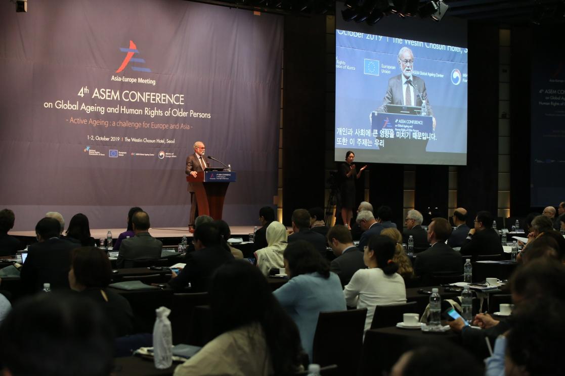 Man talking into a lectern during an event