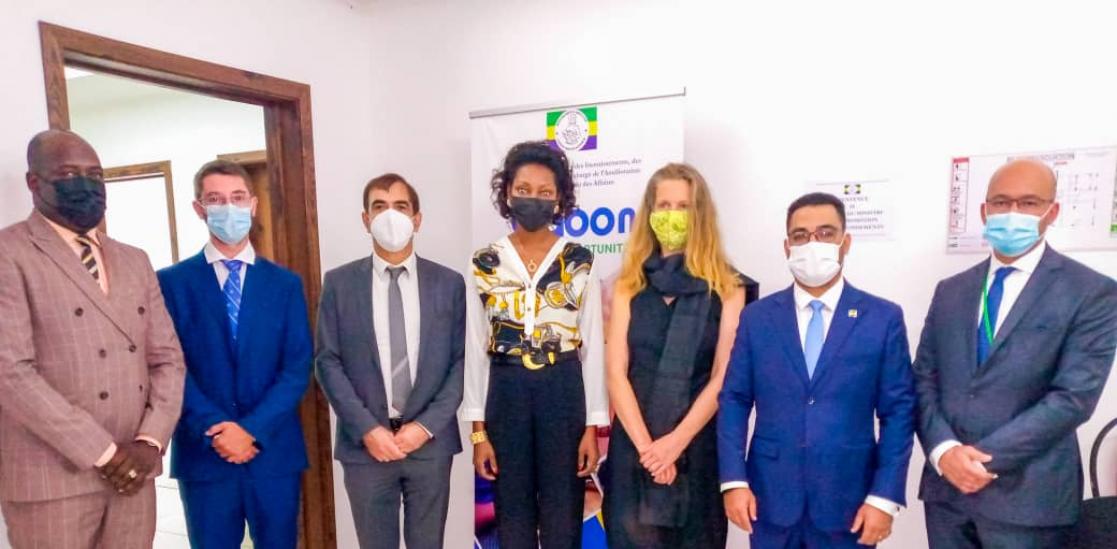 Five men and two women posing standing