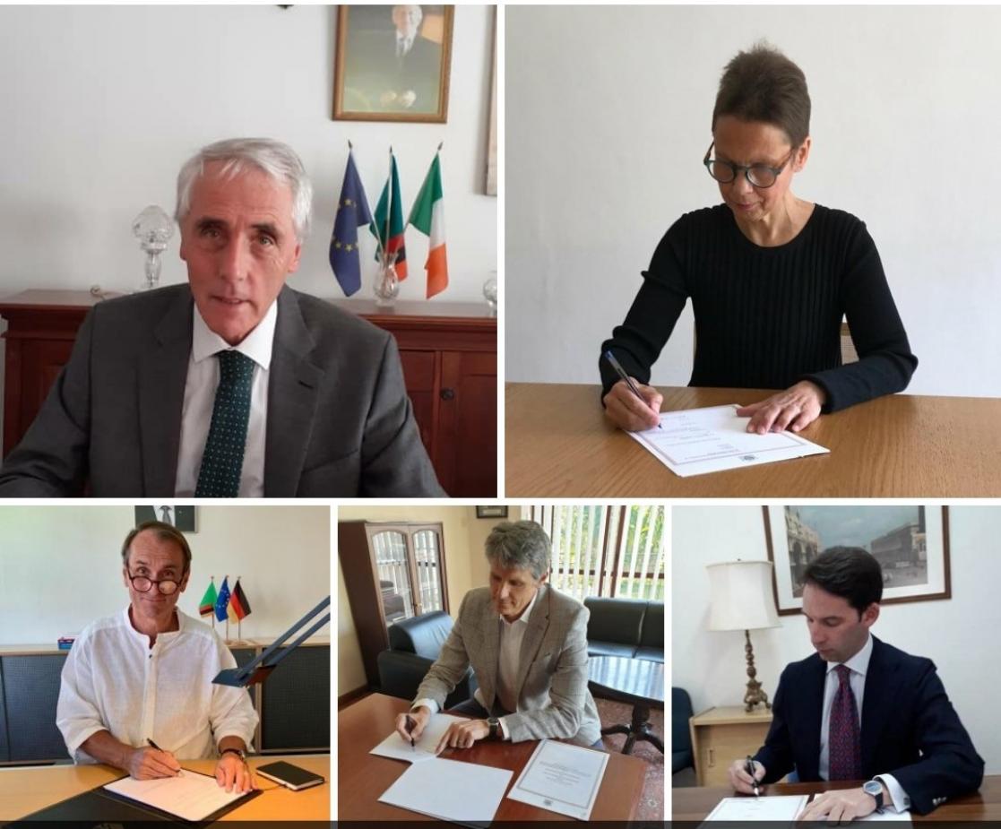 Several people signing documents