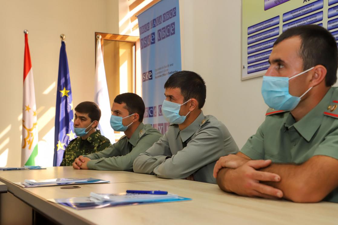 People in uniform during a meeting