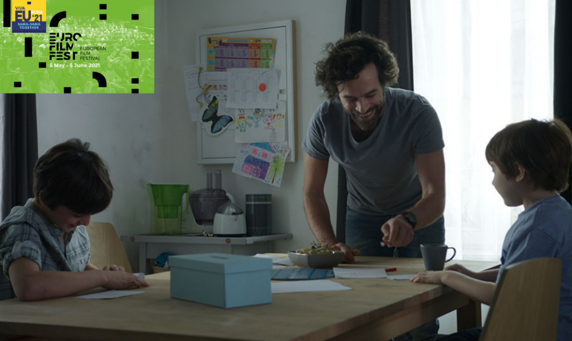 Clip of a film where a man is next to two kids