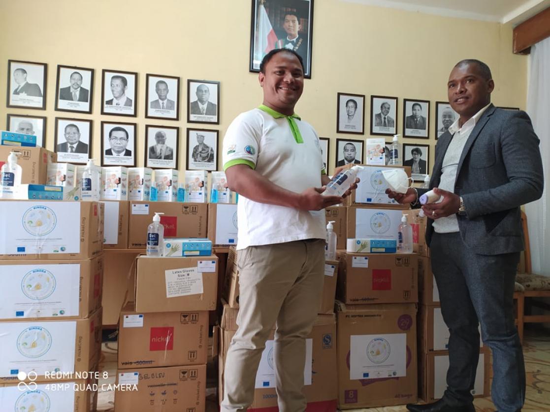 Two men with boxes of material