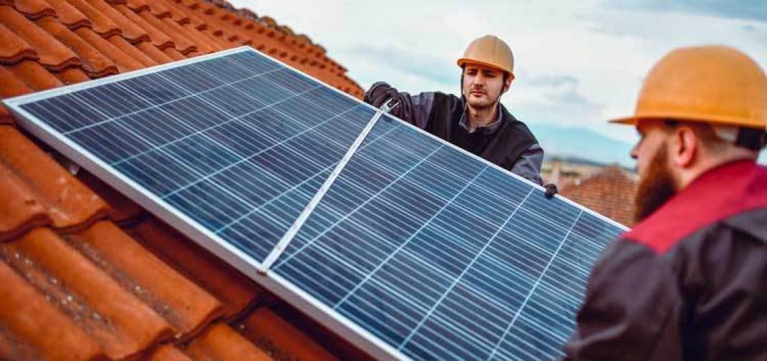 Two men working whit a solar panel