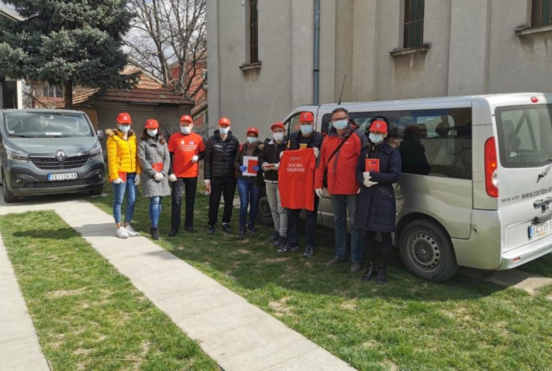 Group of people posing in front of a van