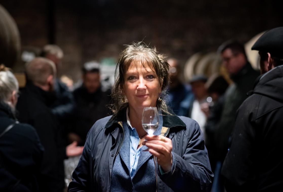 Woman holds a glass of whiskey