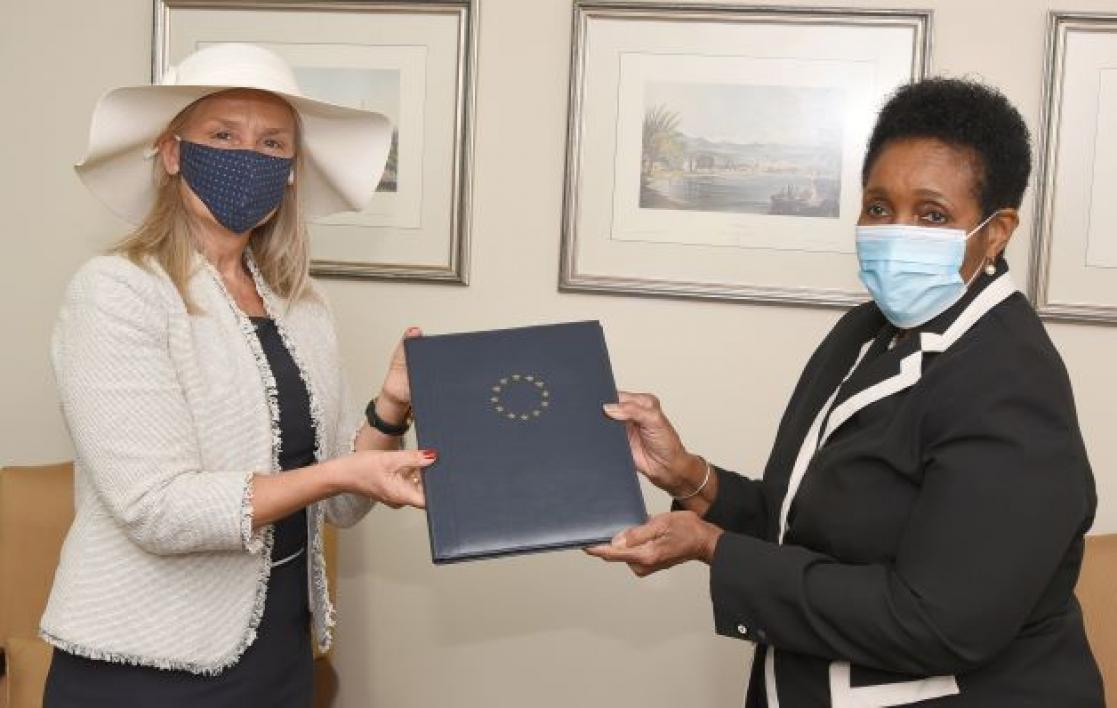 Two women exchanging documents
