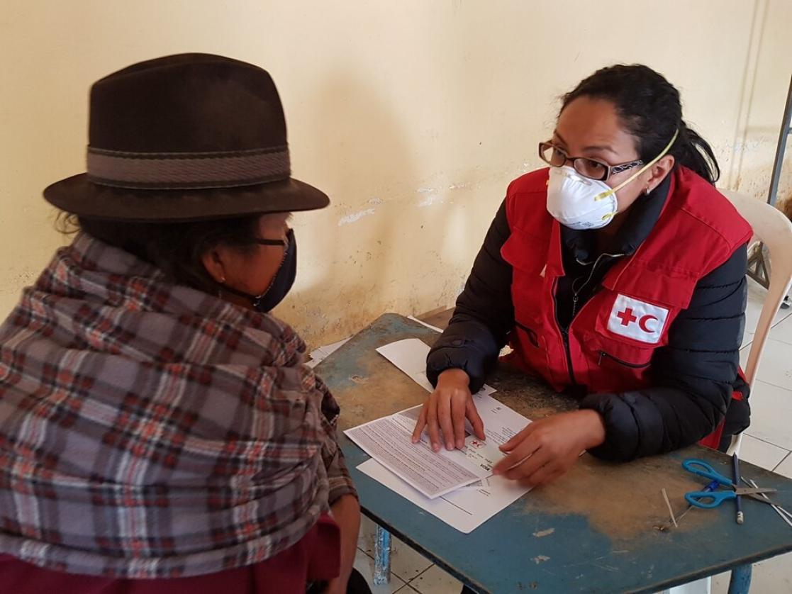 Woman Red Cross worker talking to another woman