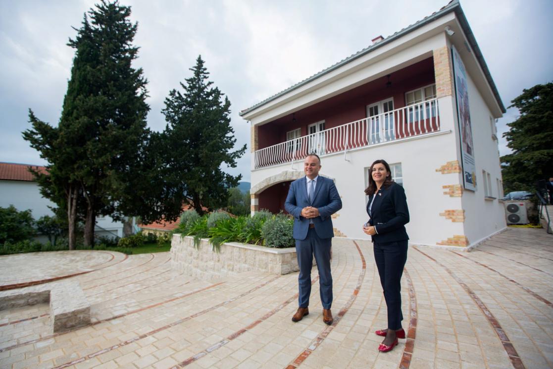 A man and a woman outside a house