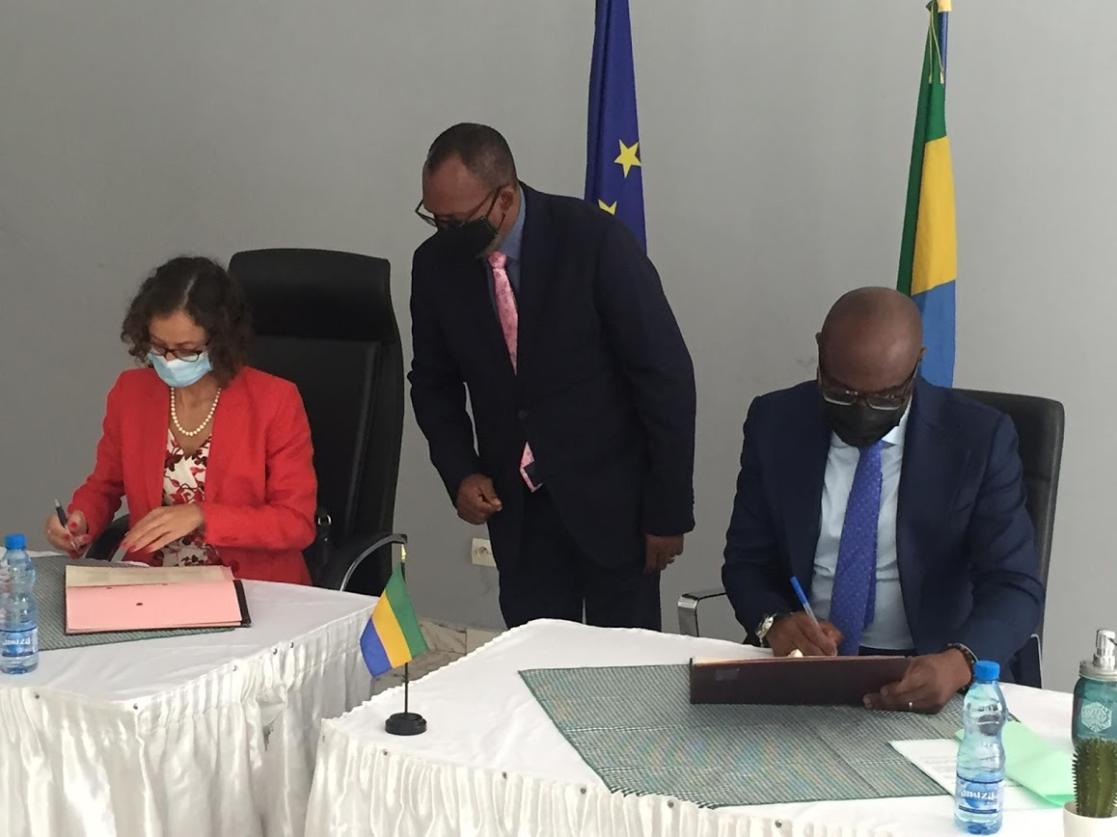 Two people signing documents