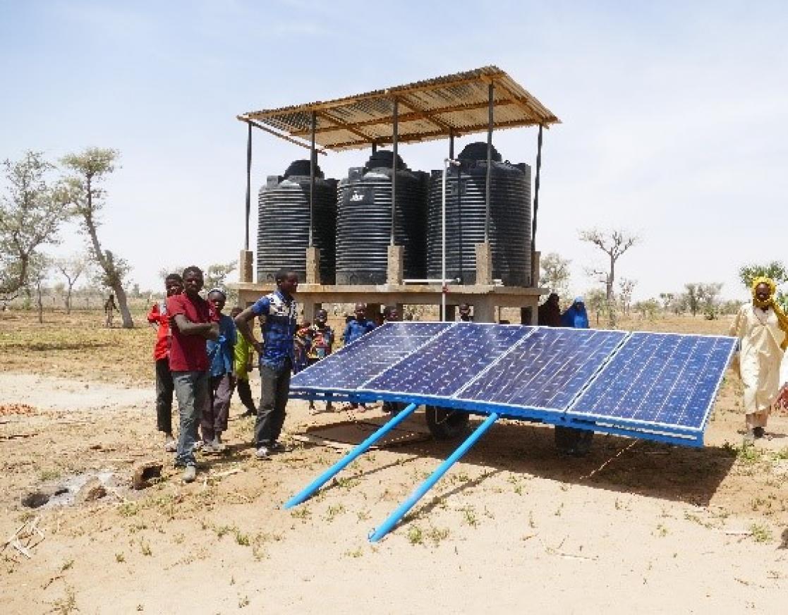 People next to a solar panel