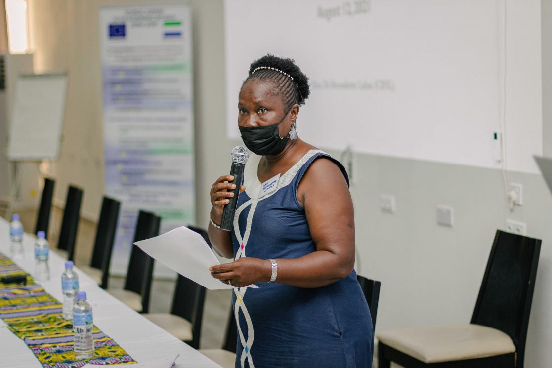 Woman talking into a microphone