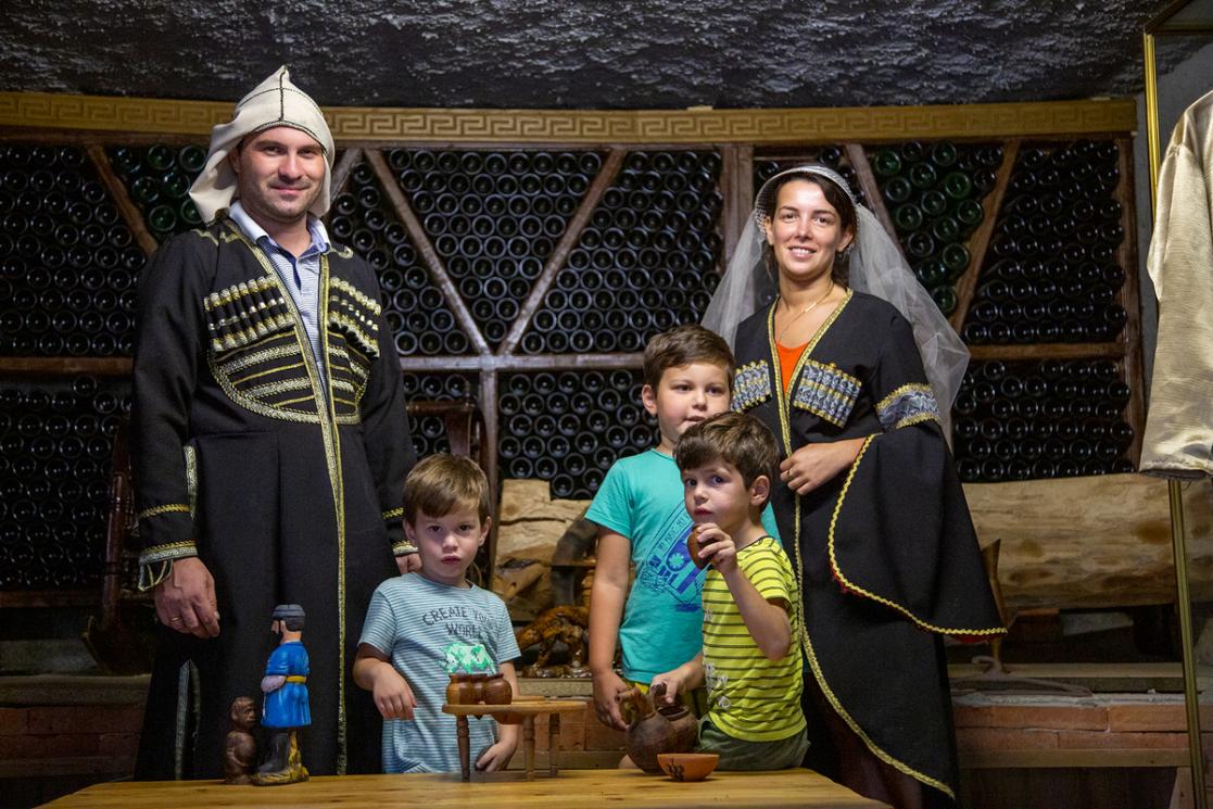 Family posing inside a winery