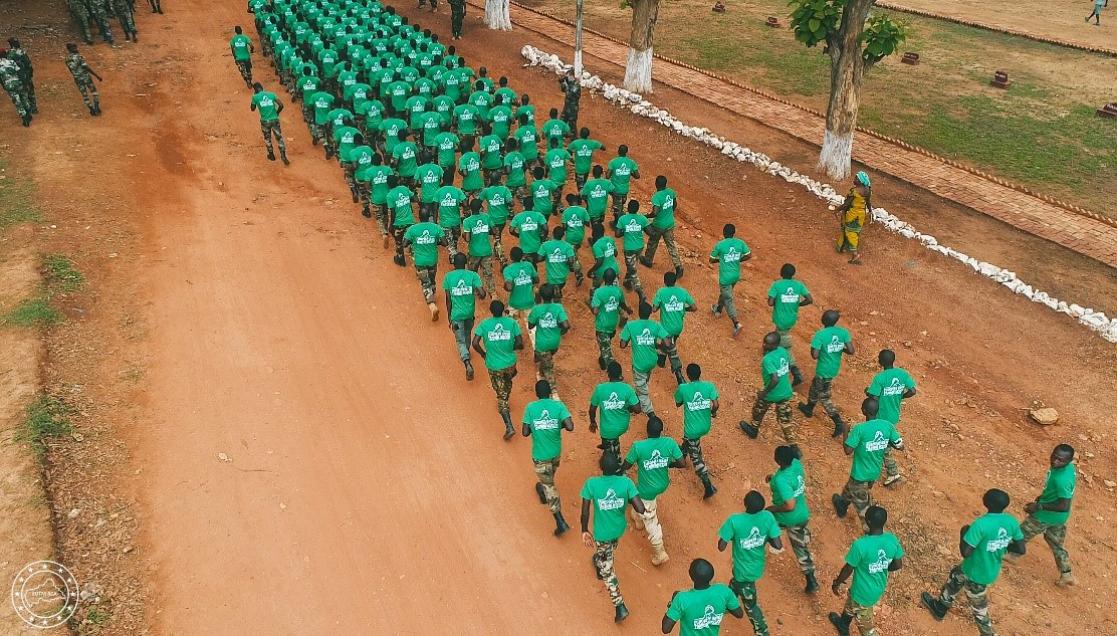 Aerial image of a group of soldiers in green T-shirts running during a training session