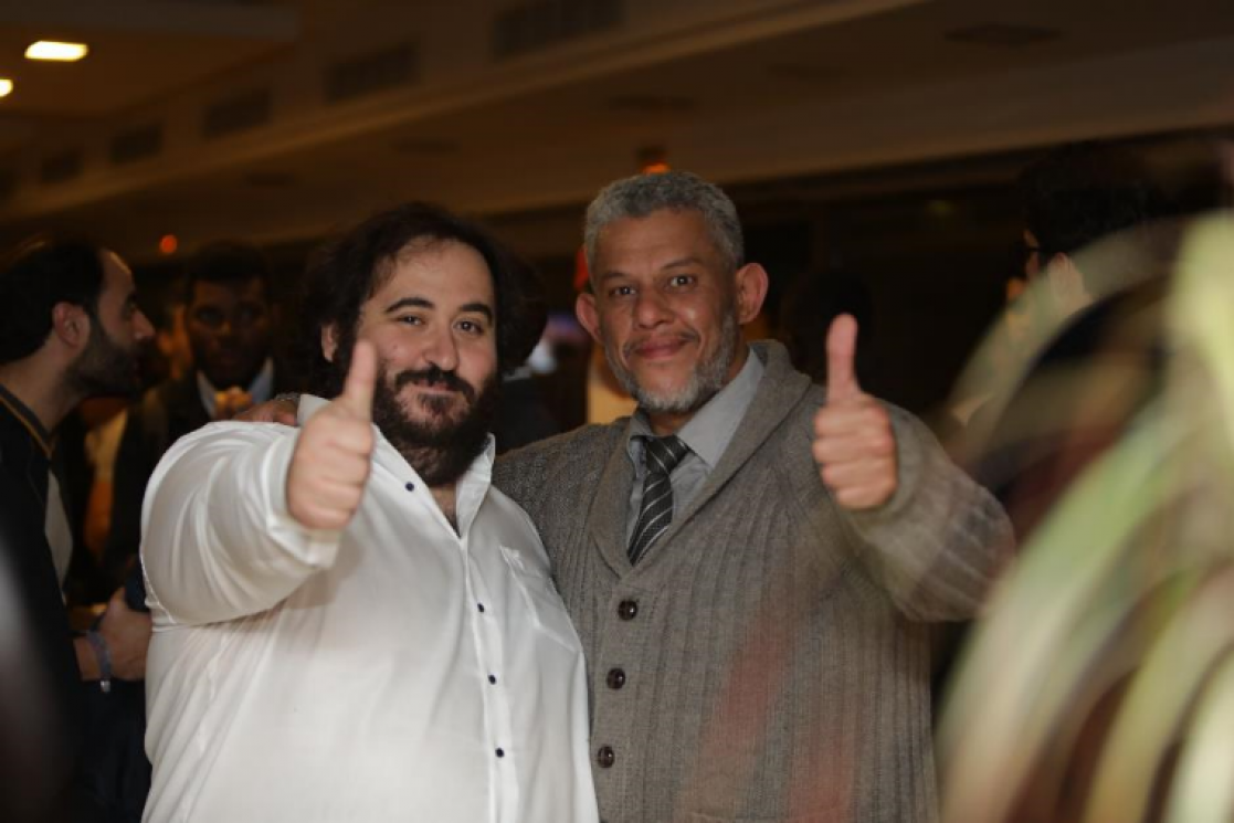 Two men similing to the camera